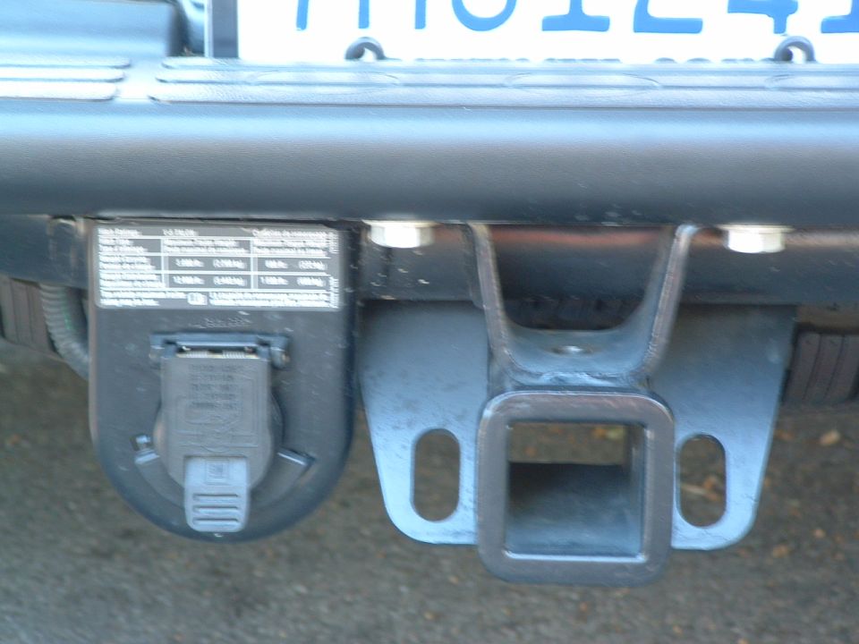 Trailer hitch receiver and 7-pin electrical connector on a vehicle's rear bumper