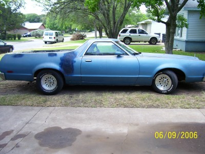 1972 Ford Ranchero - 1972 Ford Ranchero in blue with primer spots on the body, parked outside.
