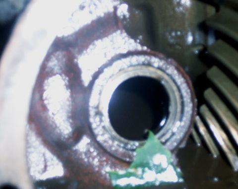 1978 Ford Bronco - A close-up view of a vehicle's differential housing and gears, showing signs of wear and fluid.