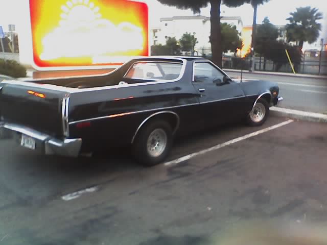 Black Ford Ranchero coupe-utility parked rear three-quarter view in lot