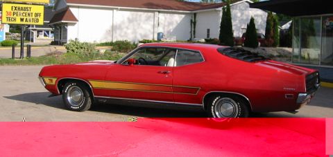 1972 Ford Ranchero - This red 1972 Ford Ranchero features a distinctive gold side stripe and rear window louvers.
