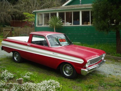 1972 Ford Ranchero - This pickup truck has a distinctive white stripe along its side and a white tonneau cover.