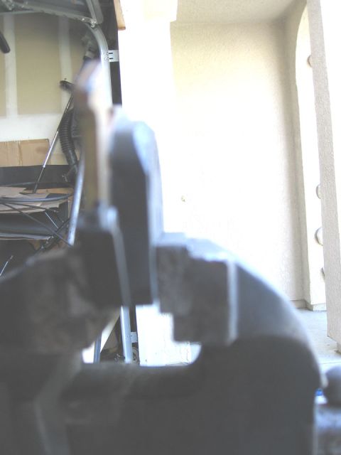 1994 Ford Bronco - A dark disc brake caliper is shown in close-up, with the background out of focus.