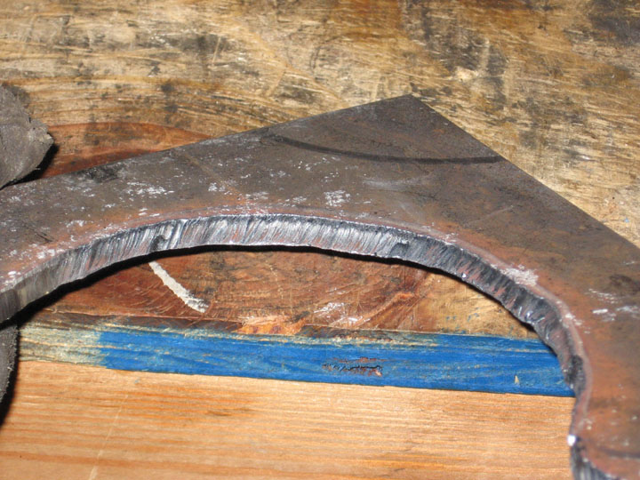 Close-up of a rough-cut metal part with visible machining marks