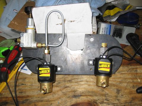 1994 Ford Bronco - JEGS solenoid valves and regulator assembly on a workbench.