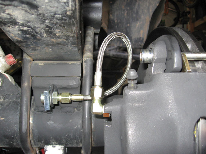 Braided stainless brake line and banjo fitting at a caliper and frame bracket