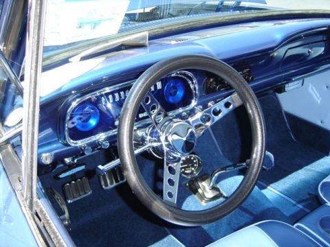1972 Ford Ranchero - The interior of a blue vehicle features a custom steering wheel and dashboard with glowing blue gauges. The registry claims it is a 1972 Fo…