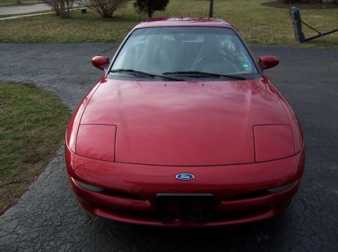1996 Ford Probe - A red 1996 Ford Probe is parked in a driveway on a sunny day.