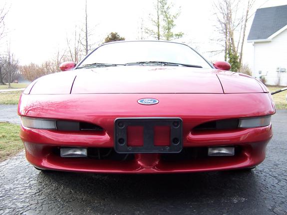 Red 1993 Ford Probe front view, showing headlights, grille, and Ford emblem