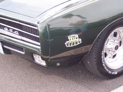 1972 Ford Ranchero - Front quarter view of a green 1969 Pontiac GTO, identified by its GTO grille and "The Judge" badging.