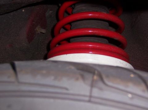 1996 Ford Probe - Suspension spring and tire detail from a vehicle.