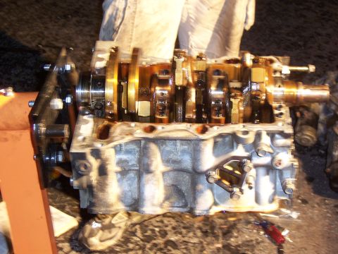 1996 Ford Probe - Engine block assembly with crankshaft and connecting rods, likely undergoing repair or rebuild.