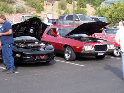1972 Ford Ranchero - A red 1972 Ford Ranchero is displayed with its hood open at a car show, alongside other vehicles.