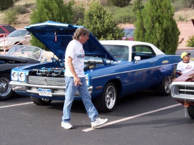 1972 Ford Ranchero - Blue 1970s coupe with hood open, parked at an outdoor event. Another vehicle is partially visible.