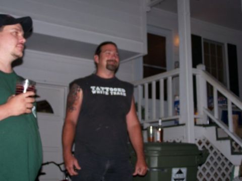 1995 Ford Bronco - Two men are standing on a porch, one holding a drink and wearing a green shirt, the other in a black t-shirt with white text.