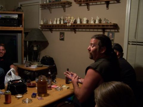 1995 Ford Bronco - A group of people are socializing in a room, with drinks and playing cards on a table.