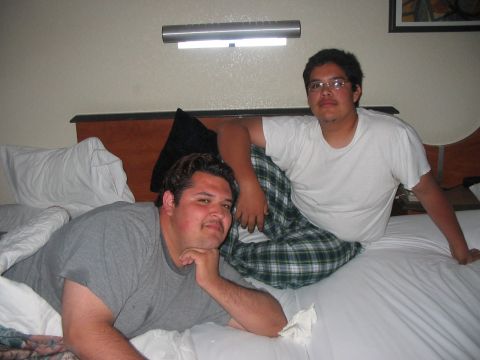 1980 Ford Bronco - Two men are relaxing on a bed in a hotel room.