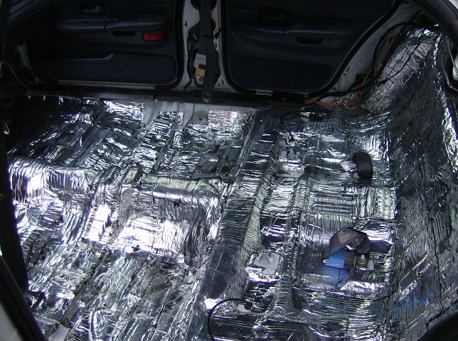 1999 Ford Crown Victoria interior with sound deadening material applied to floor and lower doors