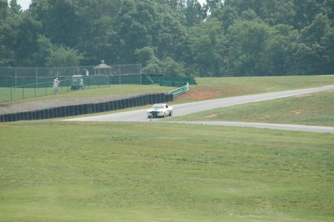 2000 Ford Mustang - A white 1969 Mustang is seen on a race track, approaching a turn.