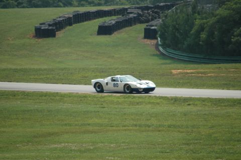 2000 Ford Mustang - A white Ford GT40 race car with blue accents and the number 80 is captured in motion on a race track.