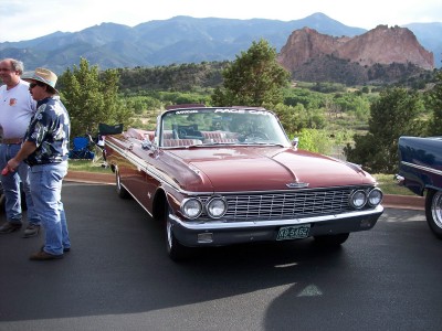 1972 Ford Ranchero - Maroon 1960 Ford Galaxie convertible parked with mountains in the background.