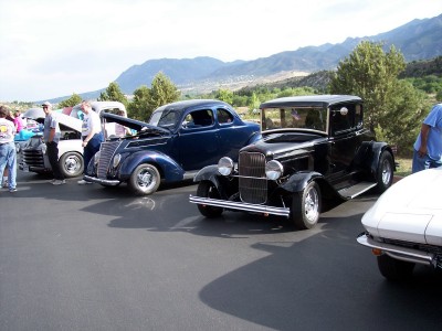 1972 Ford Ranchero - Several classic cars are lined up at an outdoor event with mountains in the background.