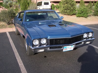 1972 Ford Ranchero - A blue 1970 Buick GSX coupe is parked in a lot, showing its distinctive grille and hood scoops.