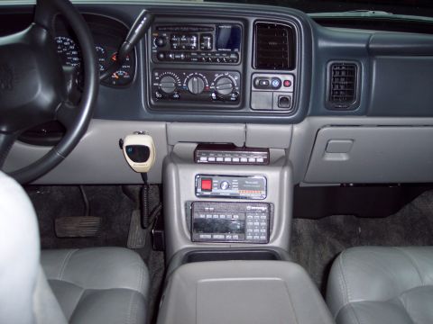 2002 Chevrolet Suburban - The interior of a 2002 Chevrolet Suburban features a dashboard with a CB radio and multiple other electronic devices mounted on the center…