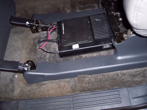 2002 Chevrolet Suburban - This photo shows radio equipment installed beneath the passenger seat of a vehicle.