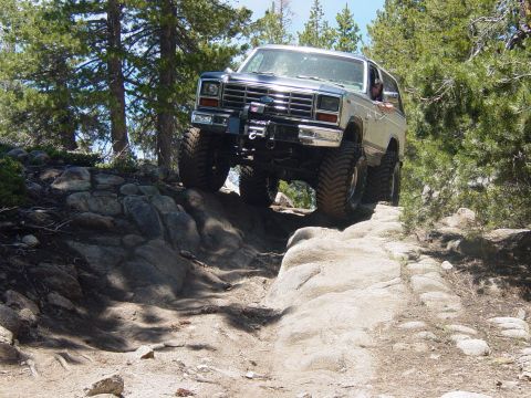 1986 Ford Bronco - A modified Ford Bronco navigates a challenging off-road course.