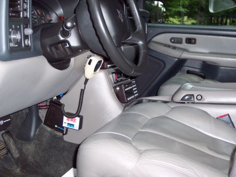 2002 Chevrolet Suburban - Interior view of a 2002 Chevrolet Suburban, showing the dashboard, steering wheel, CB radio, and gray leather seats.