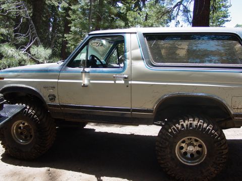 1986 Ford Bronco - This modified Ford Bronco, likely from the early 1980s, is equipped for off-road use with substantial tires.