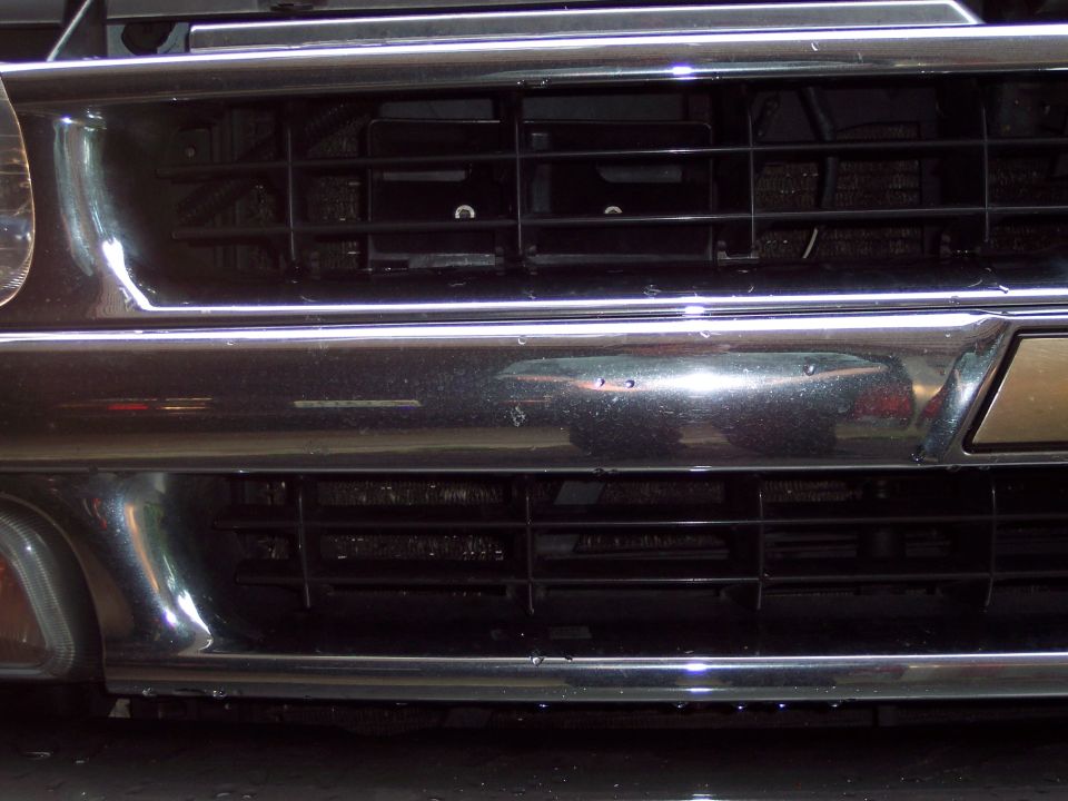 Chrome grille and bumper detail on a vehicle
