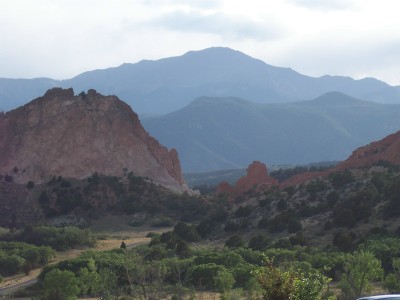 1972 Ford Ranchero - A scenic view of layered mountains and distinctive red rock formations under a cloudy sky.