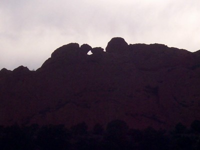 1972 Ford Ranchero - A natural rock arch is visible in the silhouette of a mountain range under an overcast sky.