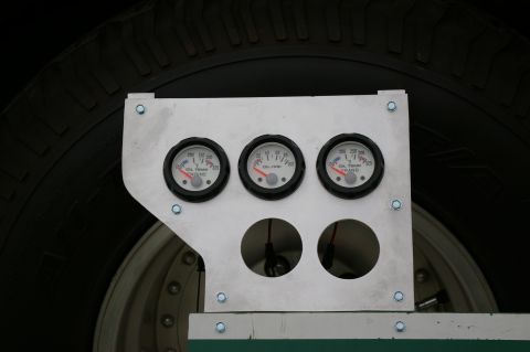 1986 Ford Bronco - A custom gauge cluster is installed in a vehicle, showing oil and transmission temperatures and oil pressure.