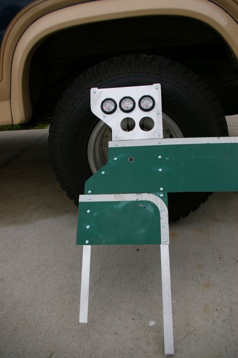 1986 Ford Bronco - Custom gauge pod with three gauges is mounted near the wheel well of a 1986 Ford Bronco.