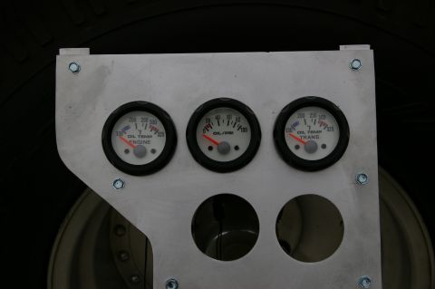 1986 Ford Bronco - A custom gauge cluster displays engine oil temperature, transmission oil temperature, and oil pressure readings.
