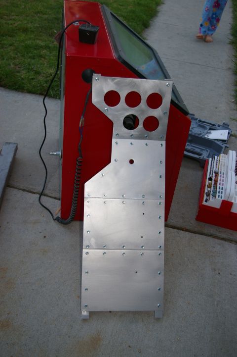 1986 Ford Bronco - A red sandblaster cabinet is shown with a metal panel attached to its front, several circular openings.
