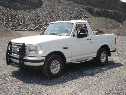1995 Ford Bronco - White 1995 Ford Bronco with a bull bar parked in a gravel quarry.