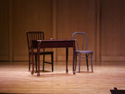 1996 Ford Probe - A simple stage set features a table and two chairs, creating a minimalist scene.