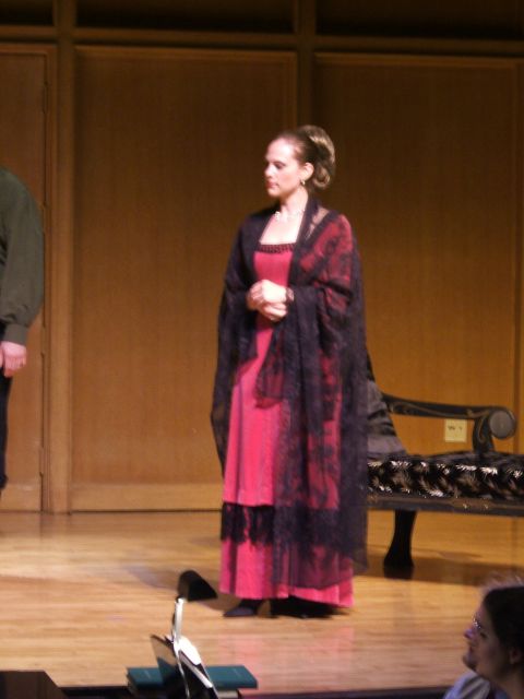 1996 Ford Probe - A woman in a pink dress and black shawl stands on a stage, looking to the side.
