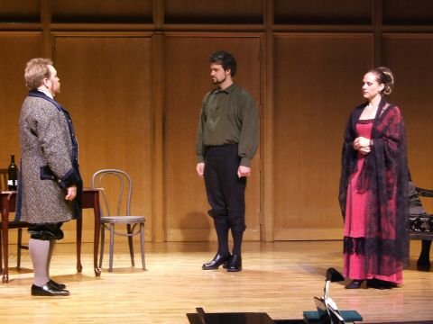 1996 Ford Probe - Three actors in historical attire stand on a stage set with wooden paneling and furniture.