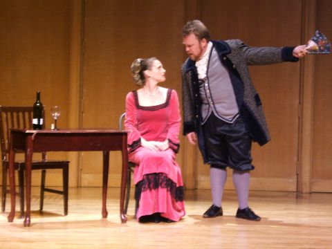 1996 Ford Probe - Actors perform on stage, dressed in period costumes, with a table and chairs as props.