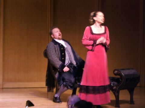1996 Ford Probe - Two actors perform on a stage in period costumes, with a dark bench to the right.