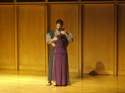 1996 Ford Probe - A theatrical scene unfolds on a wooden stage with a backdrop of paneled walls.