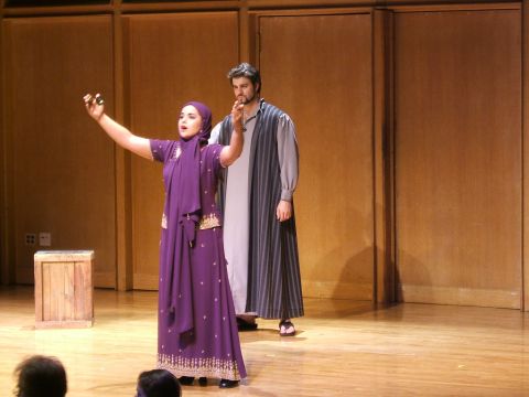 1996 Ford Probe - A theatrical performance is underway on a wooden stage with a simple backdrop.