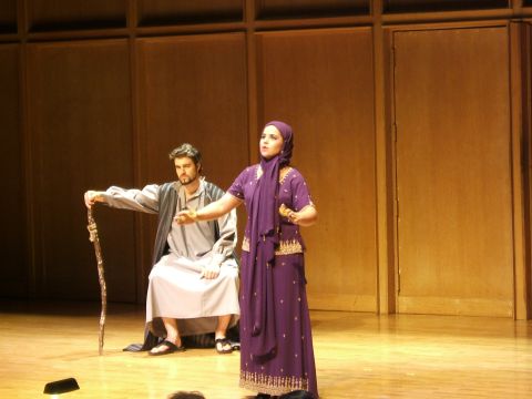 1996 Ford Probe - A theatrical performance unfolds on stage, two actors in period costumes.