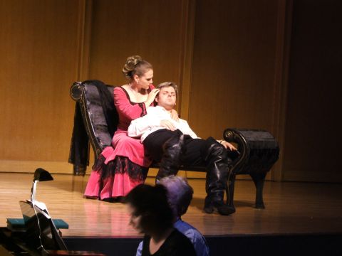 1996 Ford Probe - Actors perform a scene on stage, with a woman tending to a reclining man.