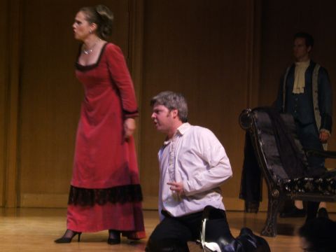 1996 Ford Probe - Actors perform on a stage in historical attire, with a woman in red and a man kneeling in white.